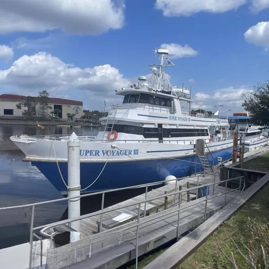 Super Voyager III Yacht Photos Pics Swiftships 1972 Commercial Passenger vessel docked, named "Super Voyager III," with blue and white exterior.