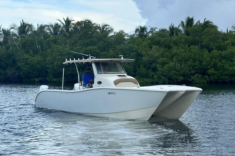 Yacht Photos Pics 2009 Mamba 350 boat cruising on a calm river with lush greenery.