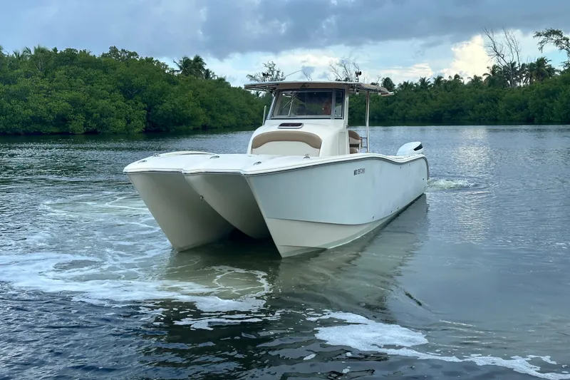  Yacht Photos Pics 2009 Mamba 350 boat cruising on a serene river with lush greenery.