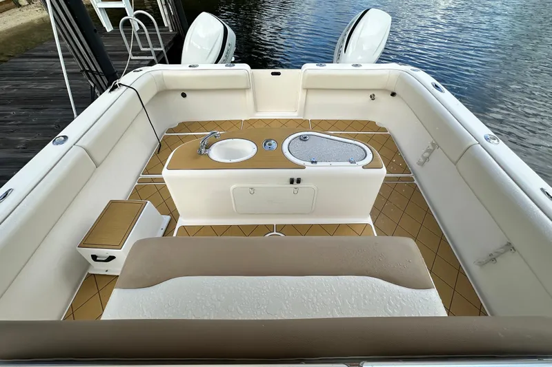  Yacht Photos Pics 2009 Mamba 350 boat interior with seating, sink, and storage, docked by the water.