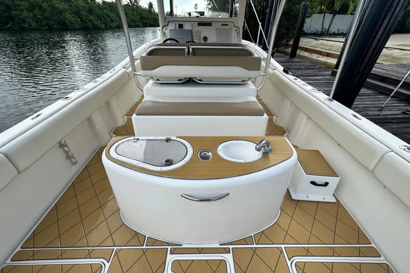  Yacht Photos Pics Interior of 2009 Mamba 350 boat with seating, sink, and storage by the water.