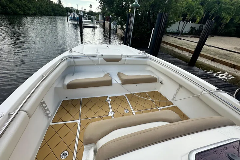  Yacht Photos Pics 2009 Mamba 350 boat with tan seating and diamond-patterned flooring docked by a serene waterway.