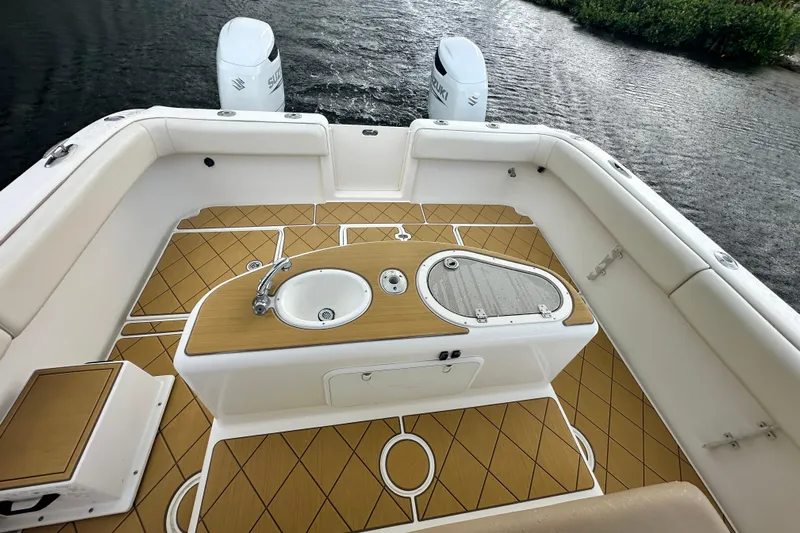  Yacht Photos Pics 2009 Mamba 350 boat interior with teak flooring and dual outboard engines.