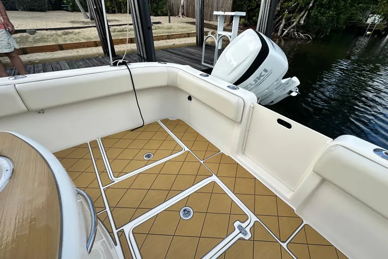  Yacht Photos Pics 2009 Mamba 350 boat interior with Suzuki outboard motor, docked by the water.