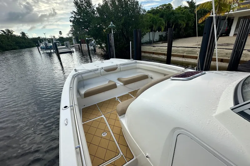  Yacht Photos Pics 2009 Mamba 350 boat docked by a serene waterfront with lush greenery.