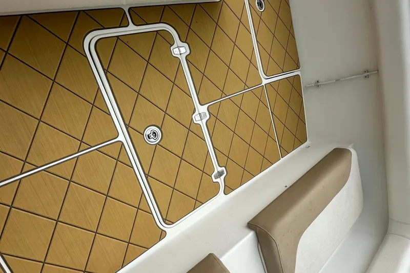  Yacht Photos Pics Interior of a 2009 Mamba 350 boat with tan diamond-patterned flooring and beige seating.