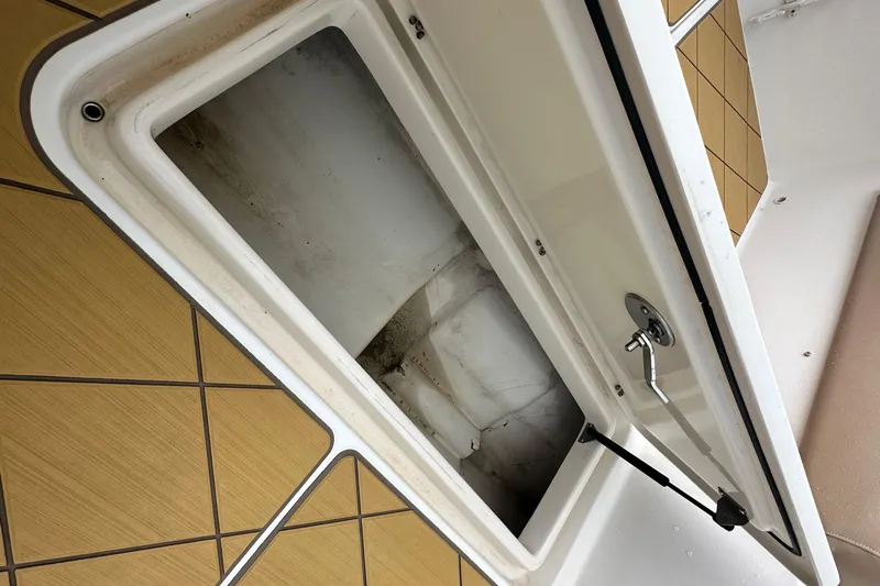  Yacht Photos Pics Open storage compartment on 2009 Mamba 350 boat with wooden paneling.
