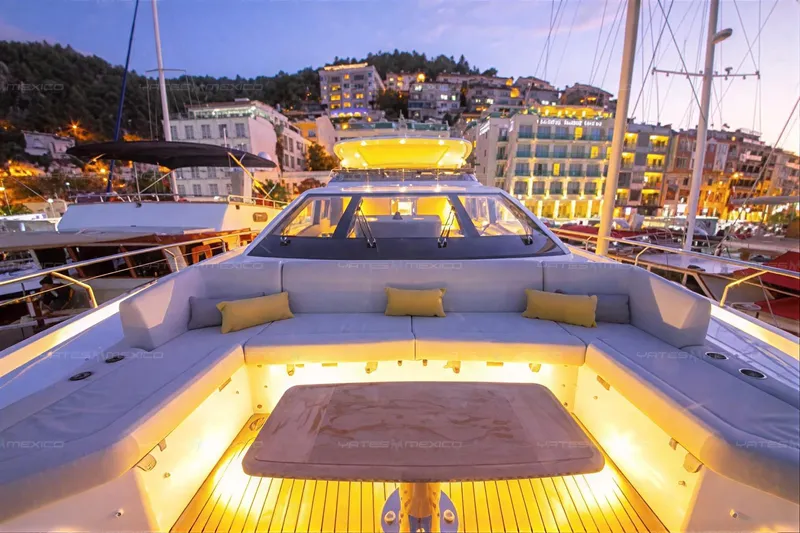 Aleph Yacht Photos Pics Luxurious 2019 Azimut Grande 27M yacht with illuminated deck, docked at scenic marina.