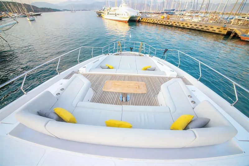 Aleph Yacht Photos Pics Luxurious 2019 Azimut Grande 27M yacht deck with seating, docked in scenic marina.