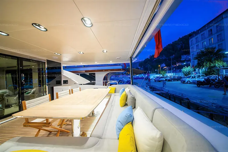 Aleph Yacht Photos Pics Luxurious 2019 Azimut Grande 27M yacht deck with elegant seating and dining area at dusk.