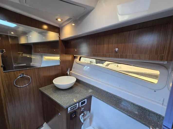 Live It Up Yacht Photos Pics Modern bathroom interior of 2020 Four Winns V355FX OB boat with wood cabinetry and vessel sink.