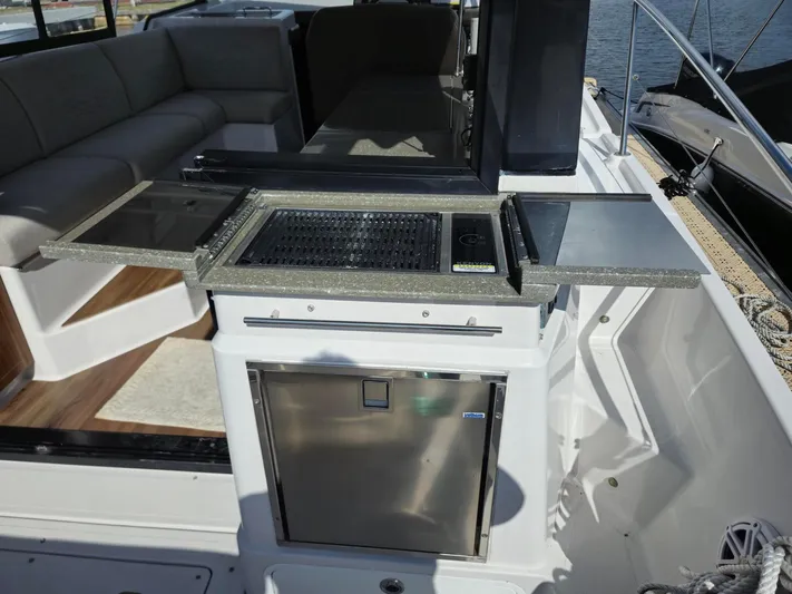 Live It Up Yacht Photos Pics 2020 Four Winns V355FX OB boat interior with kitchenette and seating area.