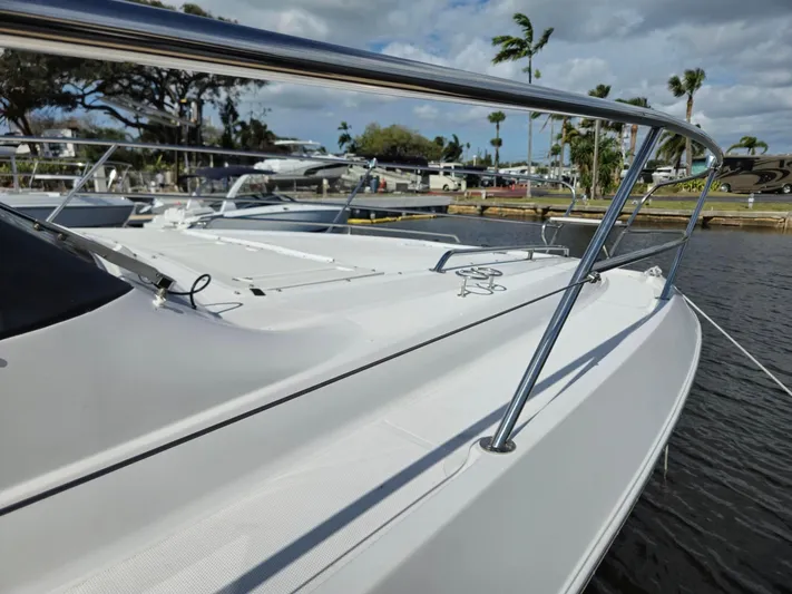 Live It Up Yacht Photos Pics 2020 Four Winns V355FX OB boat docked by the water, showcasing sleek design and railing.