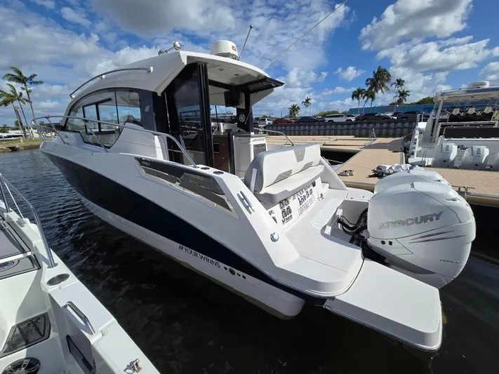 Live It Up Yacht Photos Pics 2020 Four Winns V355FX OB boat docked, featuring sleek design and Mercury outboard engine.