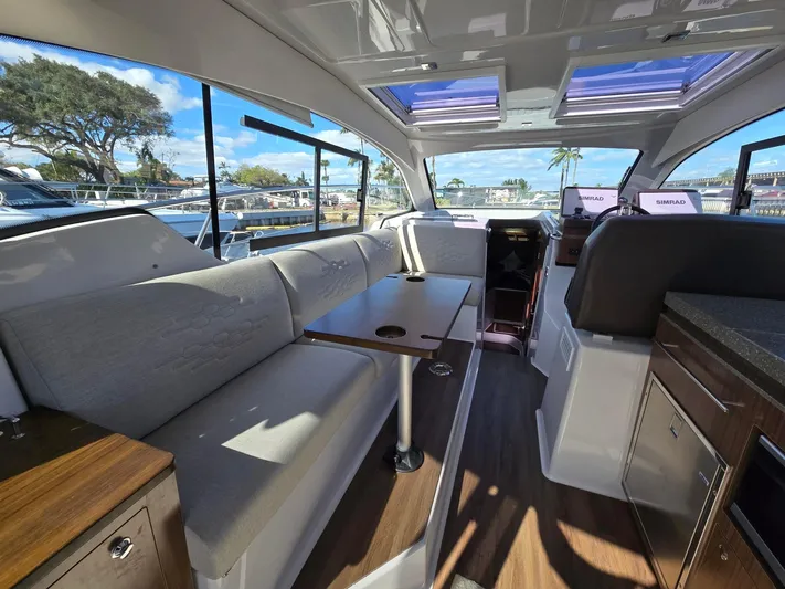 Live It Up Yacht Photos Pics 2020 Four Winns V355FX OB interior with modern seating and panoramic windows.