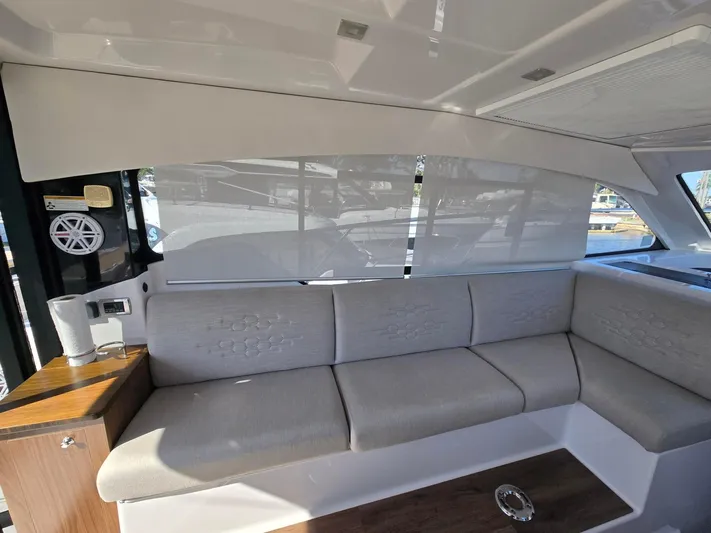 Live It Up Yacht Photos Pics Interior of 2020 Four Winns V355FX OB boat with beige seating and wooden accents.