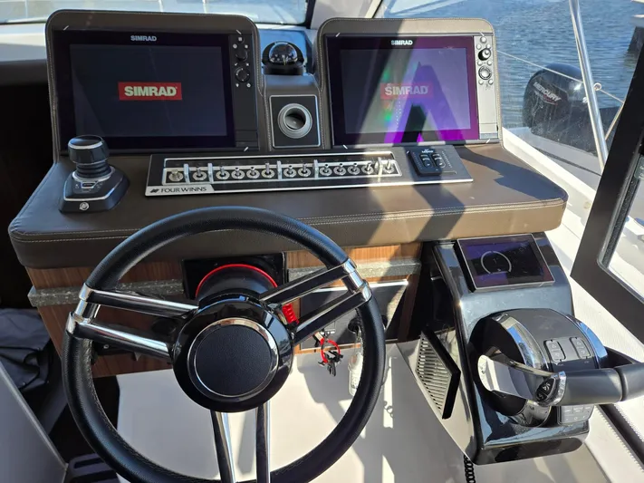 Live It Up Yacht Photos Pics 2020 Four Winns V355FX OB boat dashboard with Simrad displays and steering wheel.