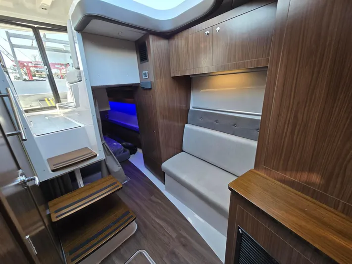 Live It Up Yacht Photos Pics 2020 Four Winns V355FX OB interior with modern wood finish and seating area.