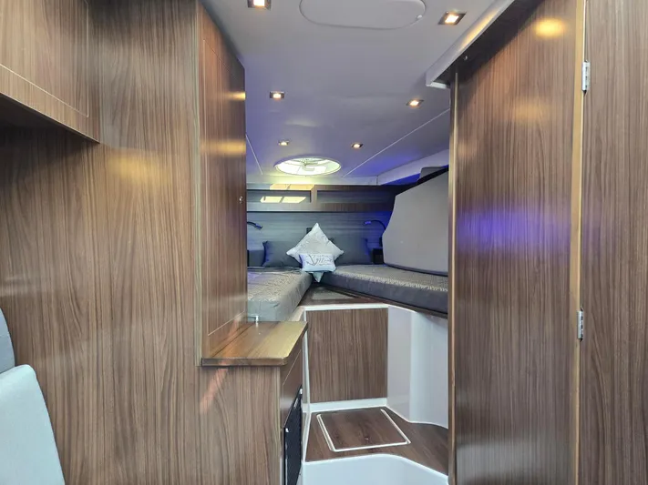 Live It Up Yacht Photos Pics 2020 Four Winns V355FX OB cabin interior with modern wood finish and ambient lighting.