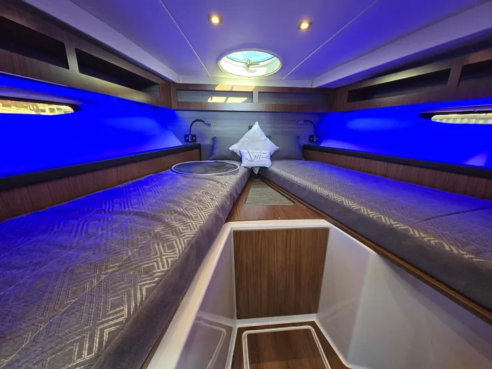Live It Up Yacht Photos Pics 2020 Four Winns V355FX OB cabin with blue lighting and twin beds.