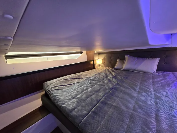 Live It Up Yacht Photos Pics 2020 Four Winns V355FX OB cabin interior with cozy bed and ambient lighting.