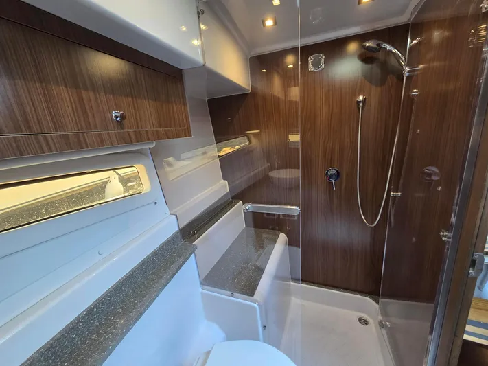 Live It Up Yacht Photos Pics 2020 Four Winns V355FX OB boat bathroom with wood accents and modern shower.