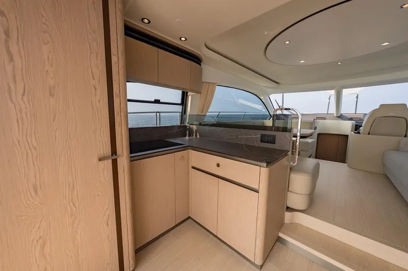  Yacht Photos Pics Luxurious interior of 2023 Azimut Fly 53 yacht, featuring modern kitchen and seating area.