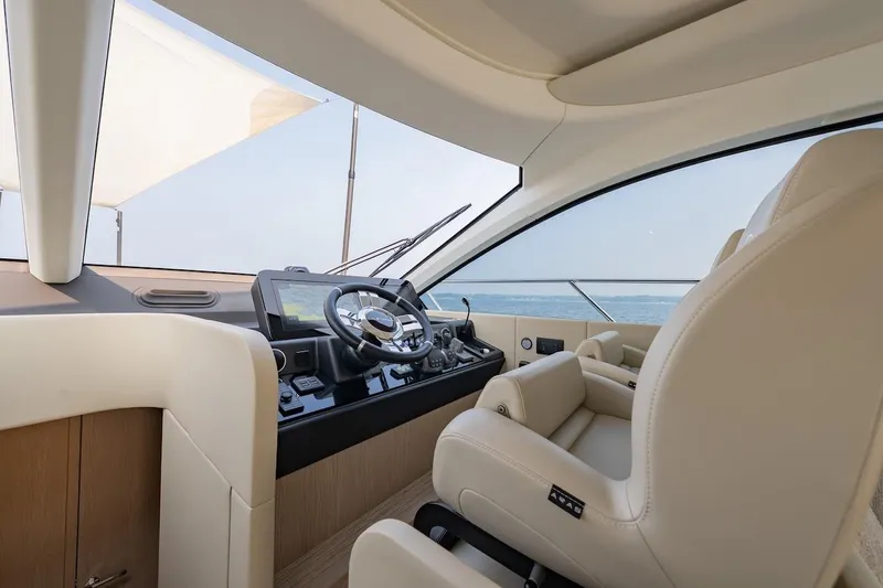  Yacht Photos Pics Luxurious interior of 2023 Azimut Fly 53 yacht with modern steering and plush seating.