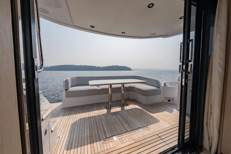  Yacht Photos Pics Luxurious 2023 Azimut Fly 53 yacht deck with seating, overlooking serene ocean view.