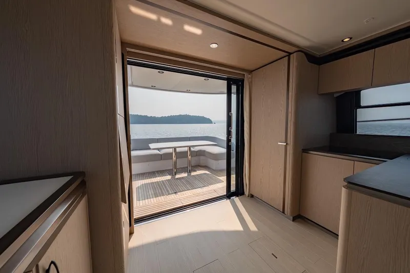  Yacht Photos Pics Interior view of 2023 Azimut Fly 53 yacht, featuring elegant wood finishes and ocean view.