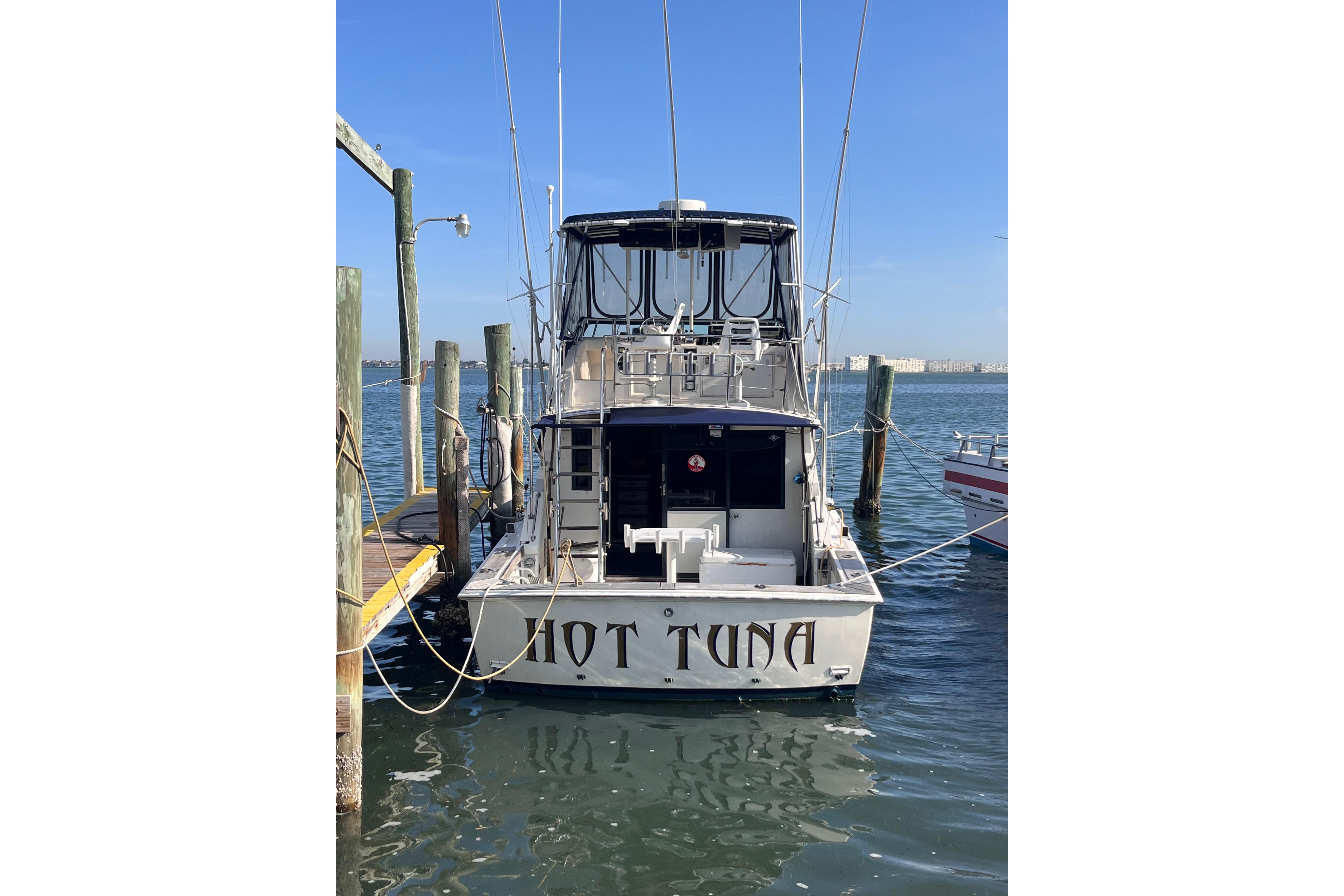 1981 Bertram 35 Sportfish boat named "Hot Tuna" docked at a marina.