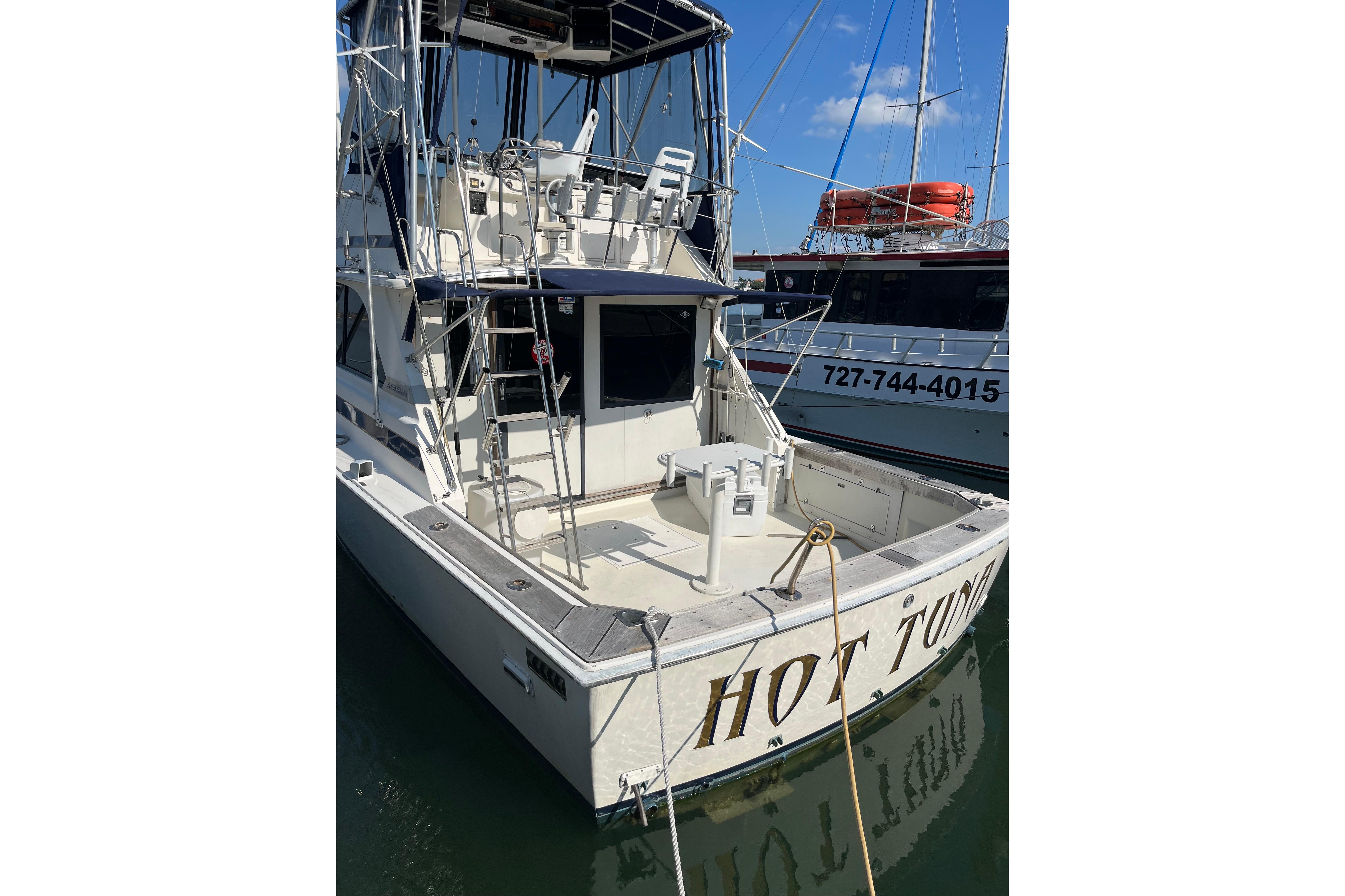 1981 Bertram 35 Sportfish boat docked, featuring a spacious deck and fishing equipment.