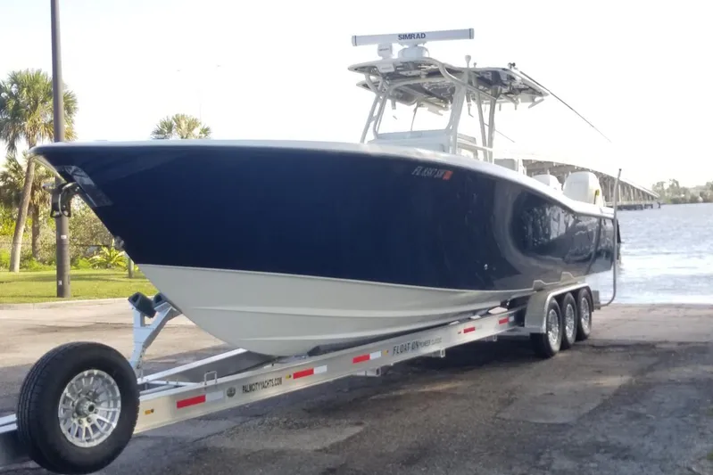  Yacht Photos Pics 2009 Invincible 36 Open Fisherman boat on trailer by waterfront.