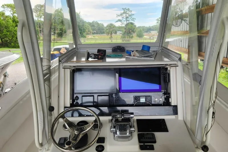  Yacht Photos Pics 2009 Invincible 36 Open Fisherman helm with navigation screens and steering wheel.