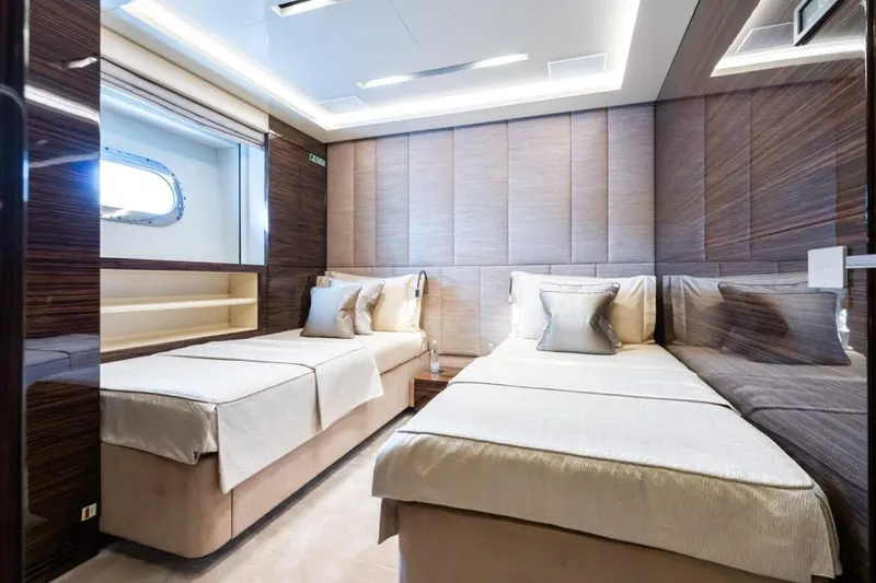 Zig Zag Ocean Yacht Photos Pics Luxurious twin bedroom on 2014 Admiral 45 METERS yacht, featuring elegant wood paneling and modern design.