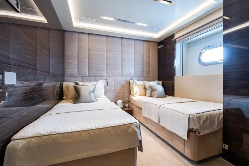 Zig Zag Ocean Yacht Photos Pics Luxurious twin bedroom on 2014 Admiral 45 METERS yacht, featuring elegant decor and modern lighting.