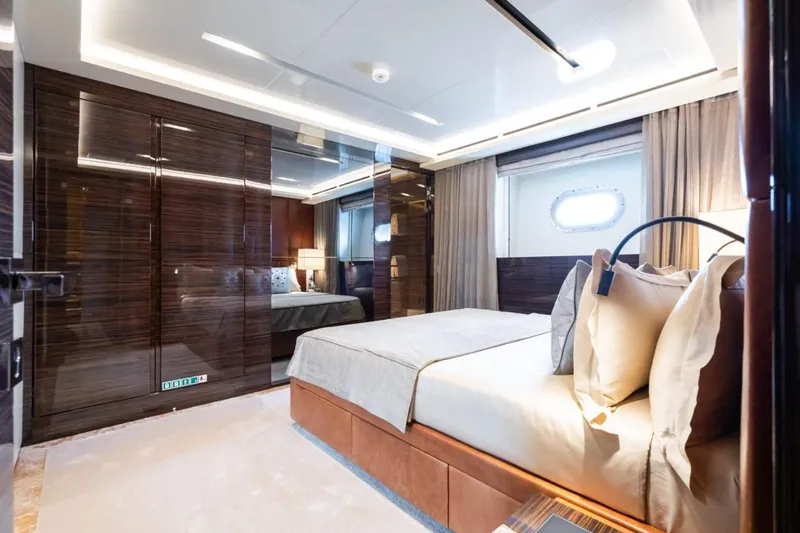 Zig Zag Ocean Yacht Photos Pics Luxurious bedroom interior on 2014 Admiral 45 Meters yacht, featuring elegant wood finishes and modern design.