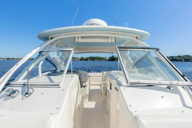  Yacht Photos Pics 2017 Grady-White Freedom 307 boat on calm water under clear blue sky.