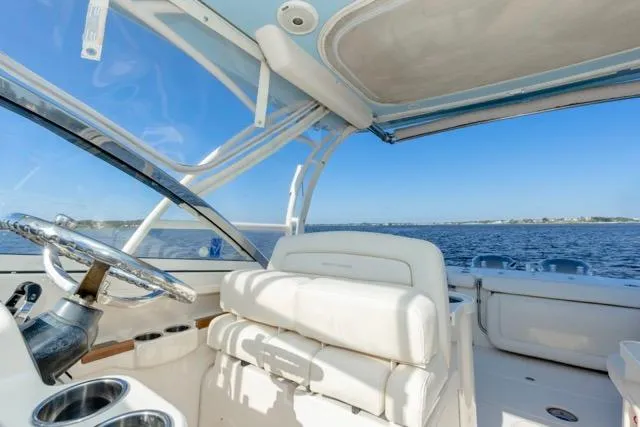  Yacht Photos Pics 2017 Grady-White Freedom 307 boat interior with ocean view, featuring white seating and steering wheel.