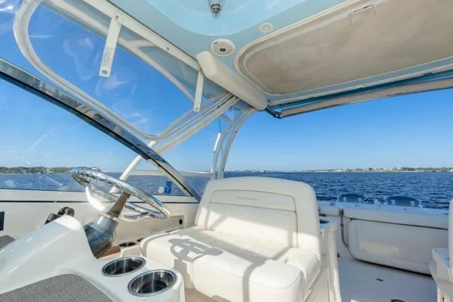 Yacht Photos Pics 2017 Grady-White Freedom 307 boat interior with ocean view, featuring helm and seating area.