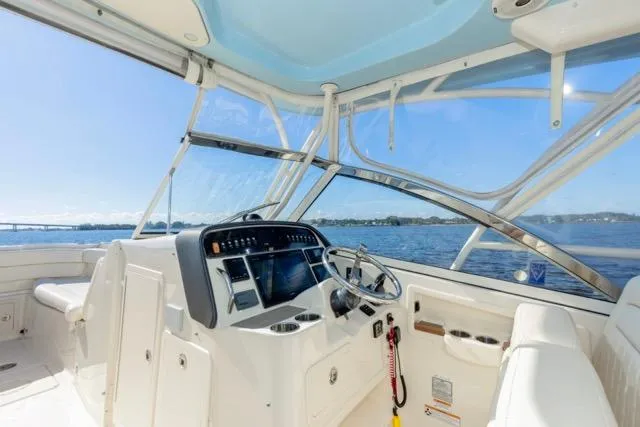  Yacht Photos Pics 2017 Grady-White Freedom 307 boat interior with steering wheel and navigation system.