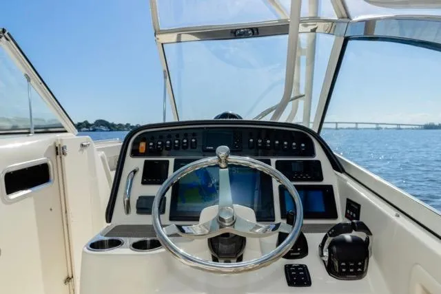  Yacht Photos Pics 2017 Grady-White Freedom 307 boat helm with steering wheel and control panel, ocean view.