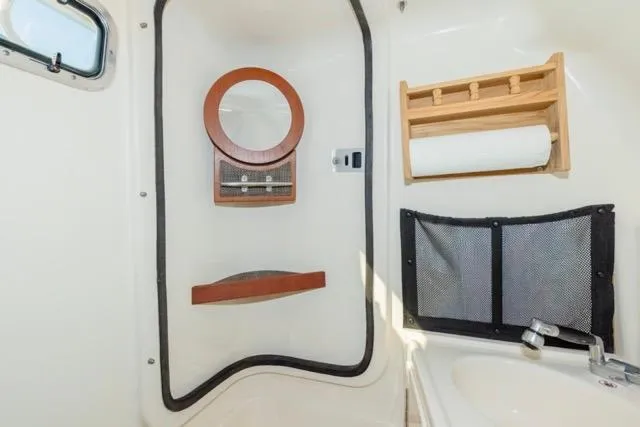  Yacht Photos Pics 2017 Grady-White Freedom 307 boat interior with mirror, storage, and sink.