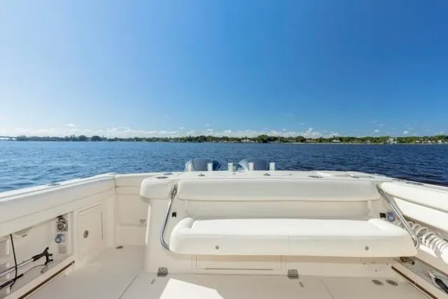  Yacht Photos Pics 2017 Grady-White Freedom 307 boat on calm water under clear blue sky.