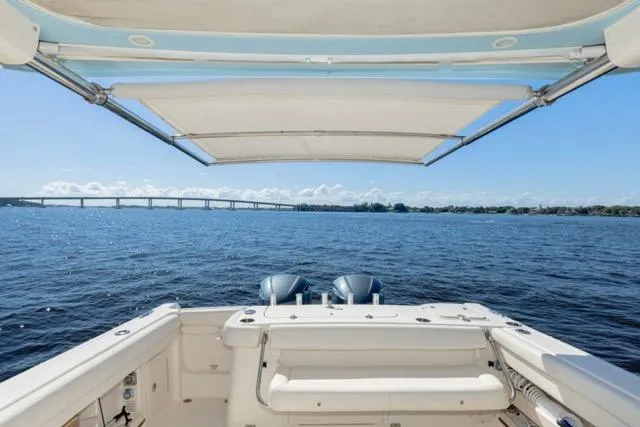  Yacht Photos Pics 2017 Grady-White Freedom 307 boat with dual engines, open water view, and bridge in the distance.