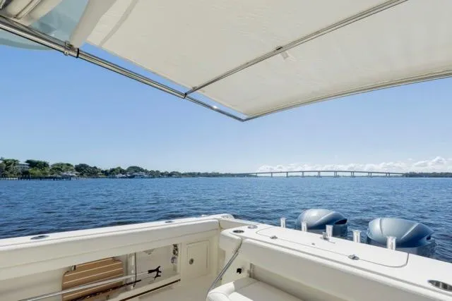  Yacht Photos Pics 2017 Grady-White Freedom 307 boat with scenic water view and bridge in the background.