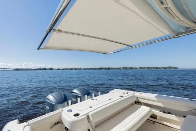  Yacht Photos Pics 2017 Grady-White Freedom 307 boat on calm water with canopy and twin engines.