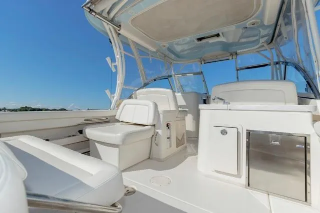  Yacht Photos Pics 2017 Grady-White Freedom 307 boat interior with seating and storage under clear blue sky.
