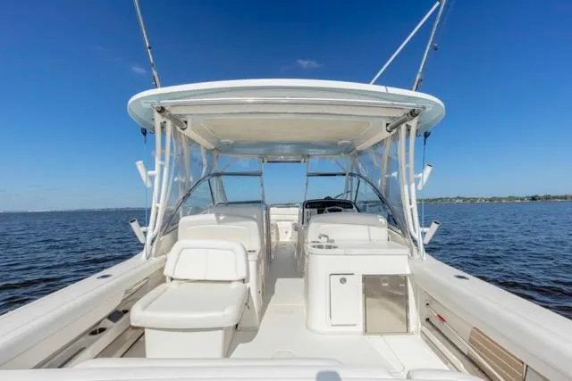  Yacht Photos Pics 2017 Grady-White Freedom 307 boat on open water, showcasing spacious seating and helm.