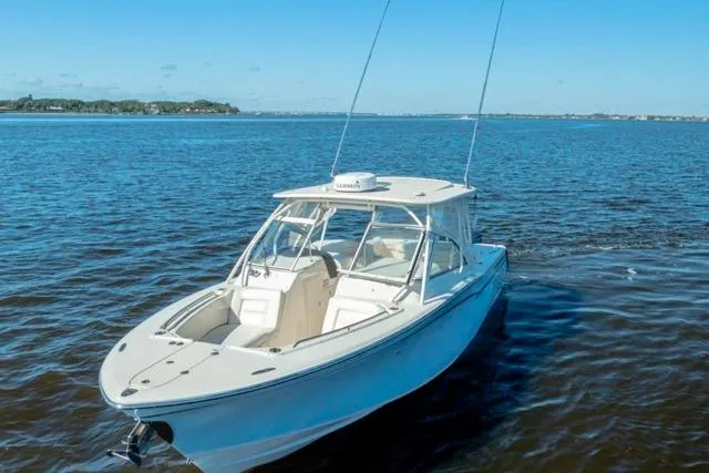  Yacht Photos Pics 2017 Grady-White Freedom 307 boat on open water under clear blue sky.